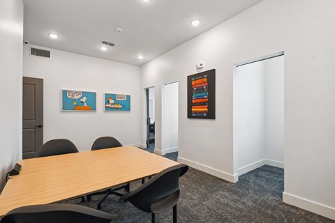 a conference room with a wooden table and chairs